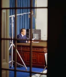 大統領執務室の窓越しに見える、ウィルソン机に座るニクソン大統領の姿。