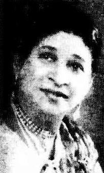 1950 年の新聞に掲載された中年の南アジア人女性の顔。首にビーズを巻き、イヤリングを垂らしている。