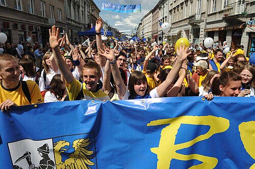 People marching behind a banner in a parade