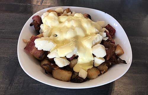 オランデーズソースとベーコンを添えた朝食用プーティン。