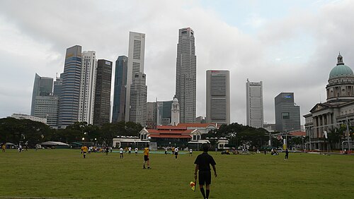 シンガポールのスカイラインを背景にした、パダンで行われたサッカーの試合。