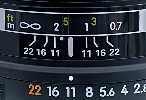 Detail from a lens set to f/11. The point half-way between the 1&nbsp;m and 2&nbsp;m marks, the DOF limits at f/11, represents the focus distance of approximately 1.33&nbsp;m (the reciprocal of the mean of the reciprocals of 1 and 2 being 4/3).