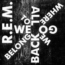 黒い背景に、左側に「REM」と白で書かれ、左から右へ時計回りに「WE / TO / ALL / WHERE / GO / WE / BACK / BELONG」と白で書かれた星型のデザイン