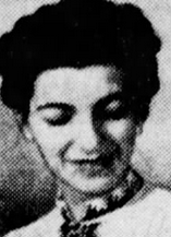 頭頂部で黒髪を三つ編みにした若い白人女性。