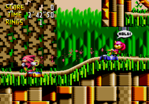Knuckles の Chaotix の最初のレベル、Isolated Island での Knuckles と Espio のゲームプレイ スクリーンショット。この特定の画面では、ゲームの協力的な「輪ゴム」物理が動作している様子が示されています。