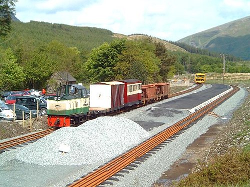 2003 年 5 月 26 日、建設の最終段階にある Rhyd Ddu 駅の北側の眺め。ディーゼル機関車 Conway Castle が、背景にタンピング マシンを備えた PW 列車を牽引しています。